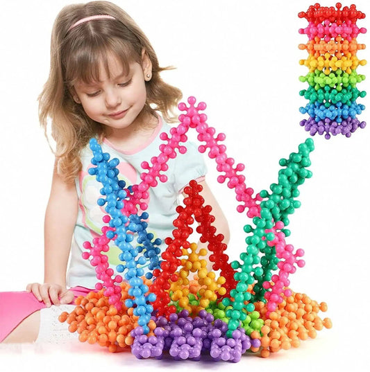 Colorful 3D interlocking bead blocks toy set, child pressing pieces into a tall rainbow arch