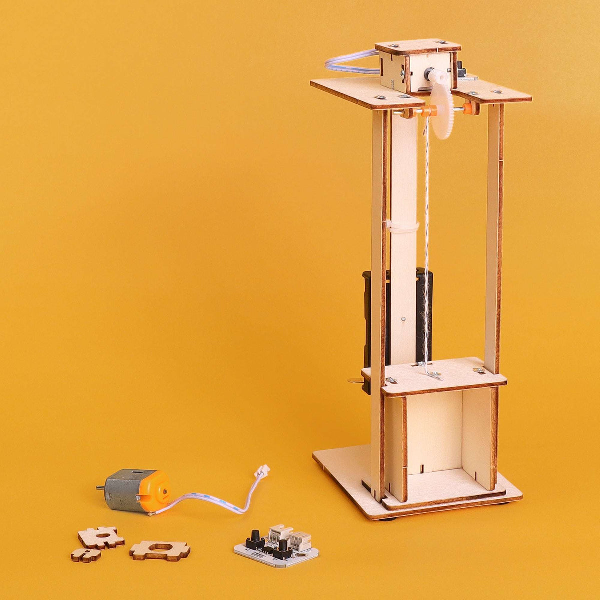 Electric elevator DIY kit with motor module, pulley cables, and open lift box on base