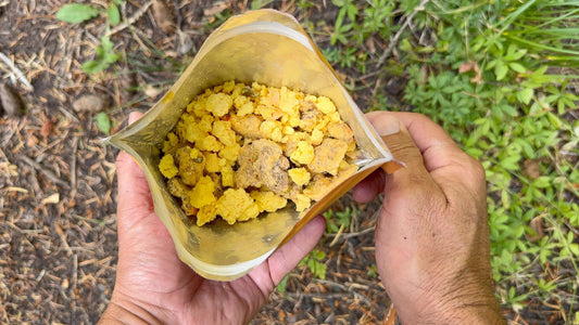Opened foil pouch with yellow scrambled egg mixture and meat crumbles outdoors meal