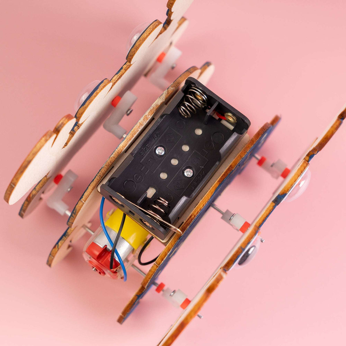 Walking crab STEM kit, close-up of battery box, springs, and colorful wiring