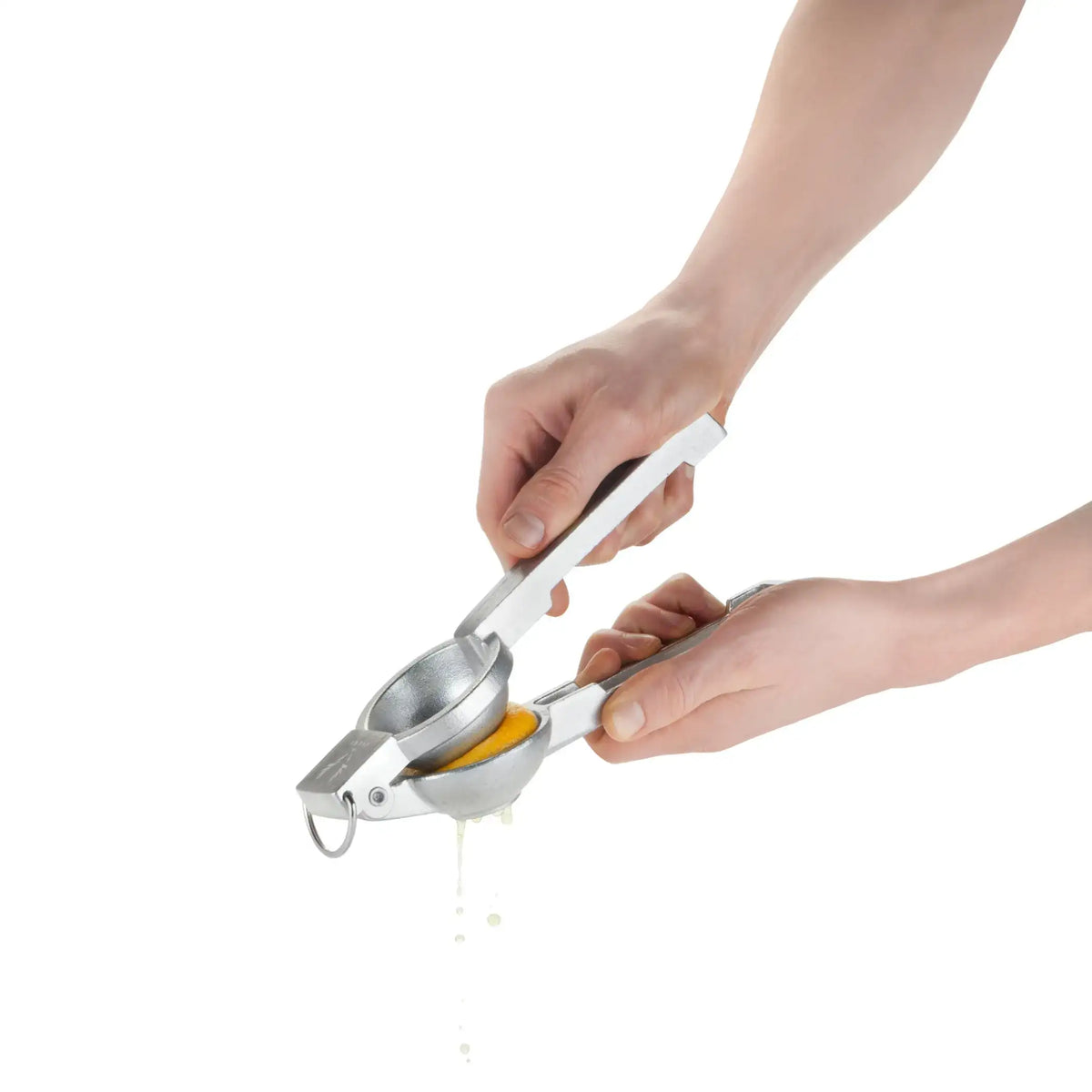 Viski citrus press close-up: hands pressing citrus onto round reamer