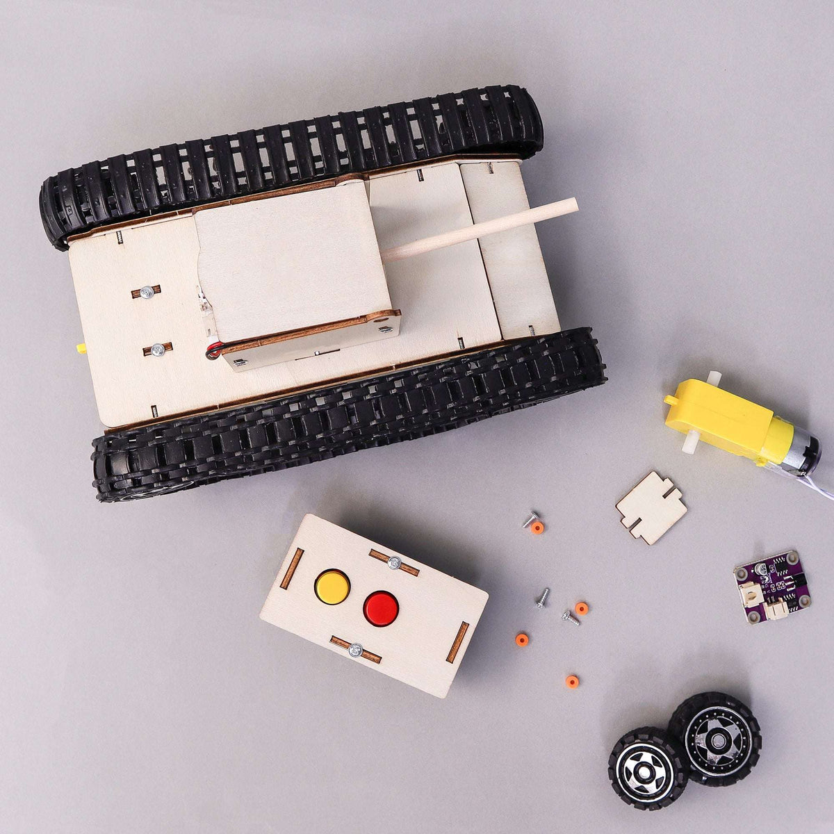 Remote-control tank DIY kit components: chassis, wheels, yellow motor, controller board