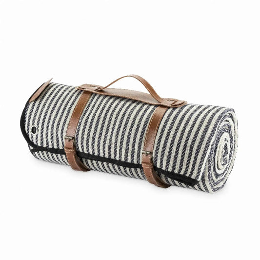 Rolled blue striped picnic blanket with leather handle carrier and strap