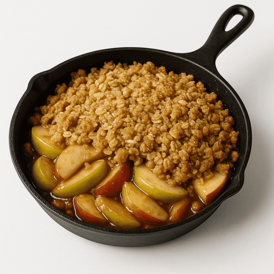 Cast-iron skillet of apple crisp with sliced apples and crunchy topping