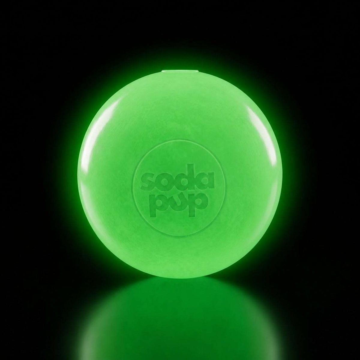 Neon green squeaky dog ball with embossed SodaPup logo, glowing