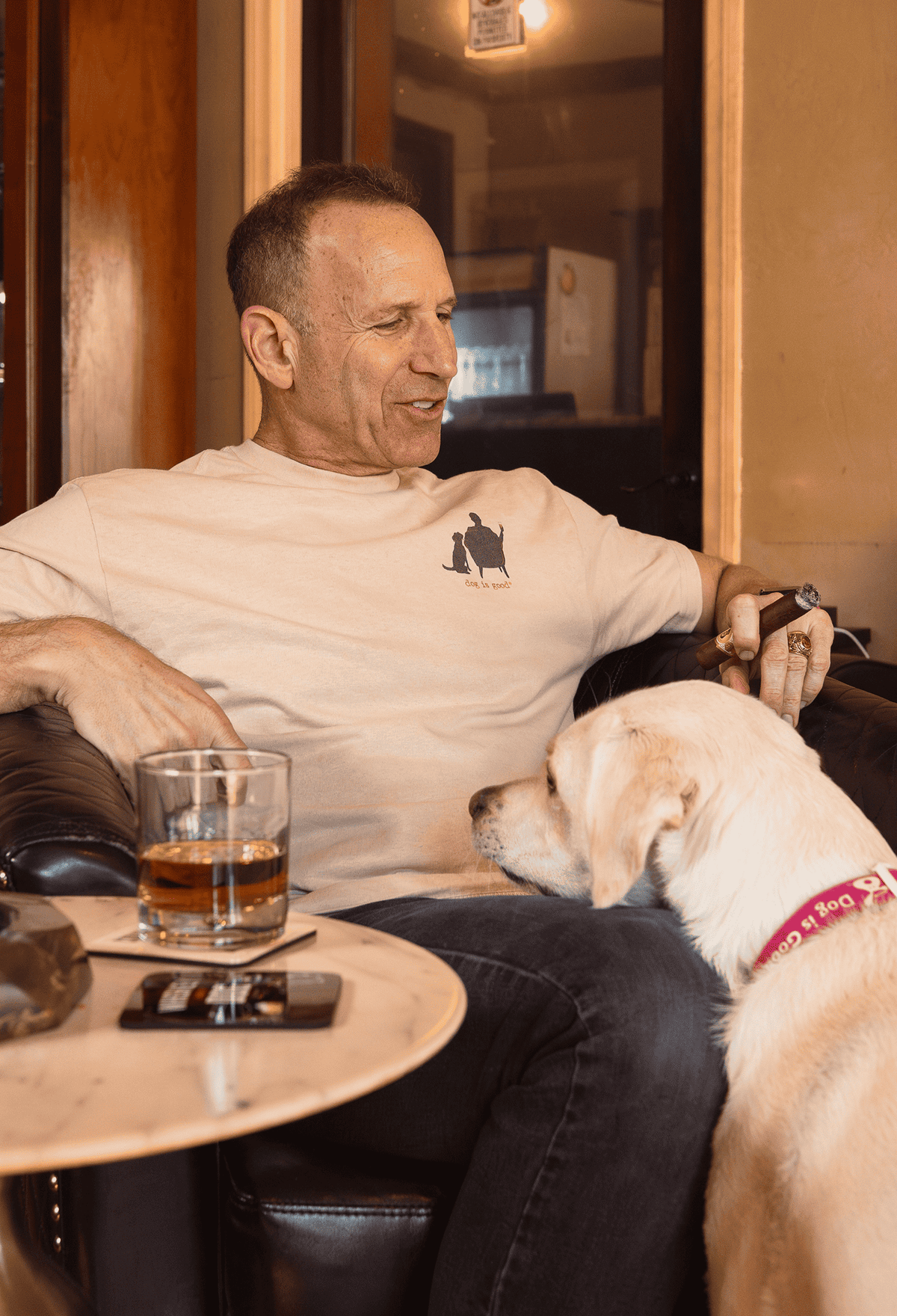 Tan cotton T-shirt with small front dog-and-person graphic