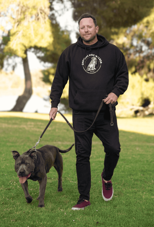 Black pullover hoodie with circular dog-walker graphic on chest
