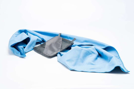 Blue microfiber towel folded with gray storage pouch and mesh strap