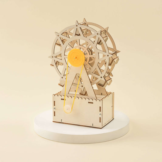 Laser-cut ferris wheel mechanical music box with orange center wheel and wooden stand