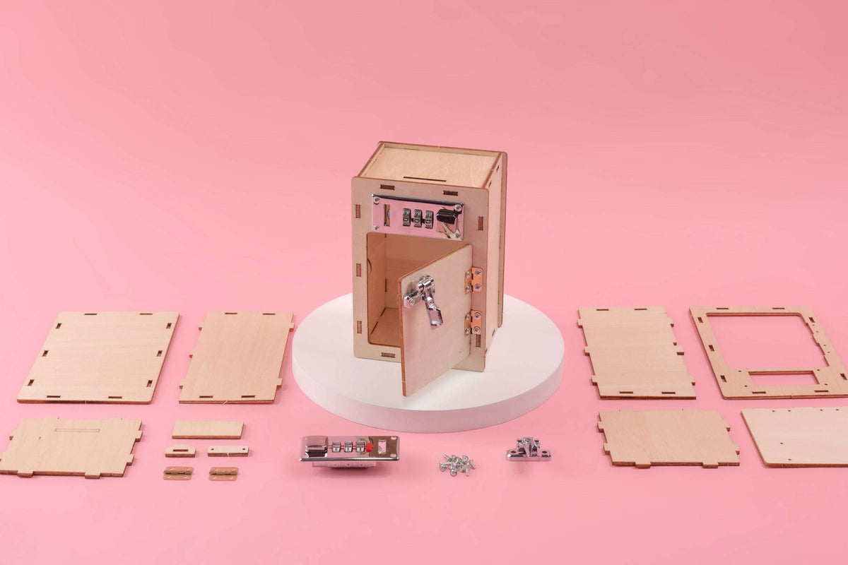 Wooden lock box kit parts laid out with lock panel, panels, and metal pieces