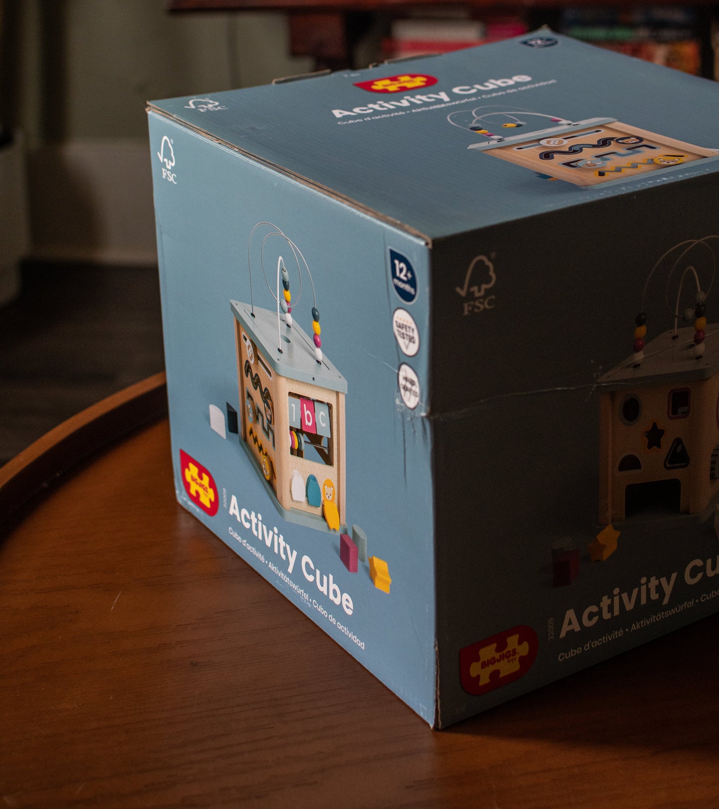 Activity cube toy box with printed product image and branding