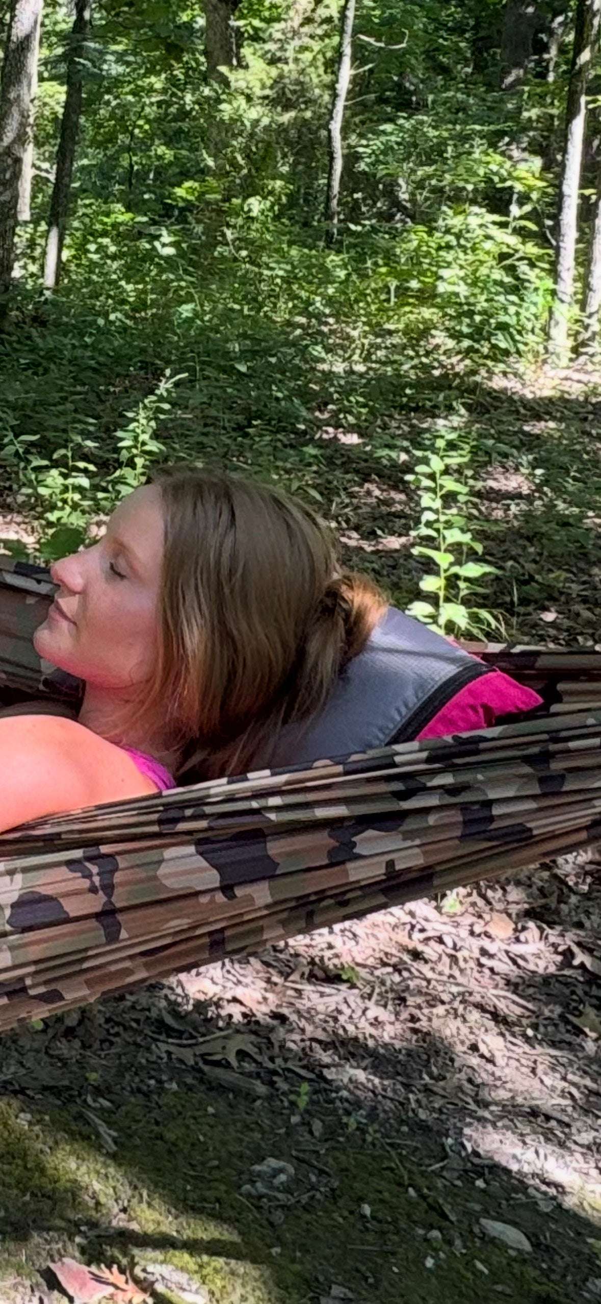 Stuff sack pillow with zipper top and cord loop closure in hammock.