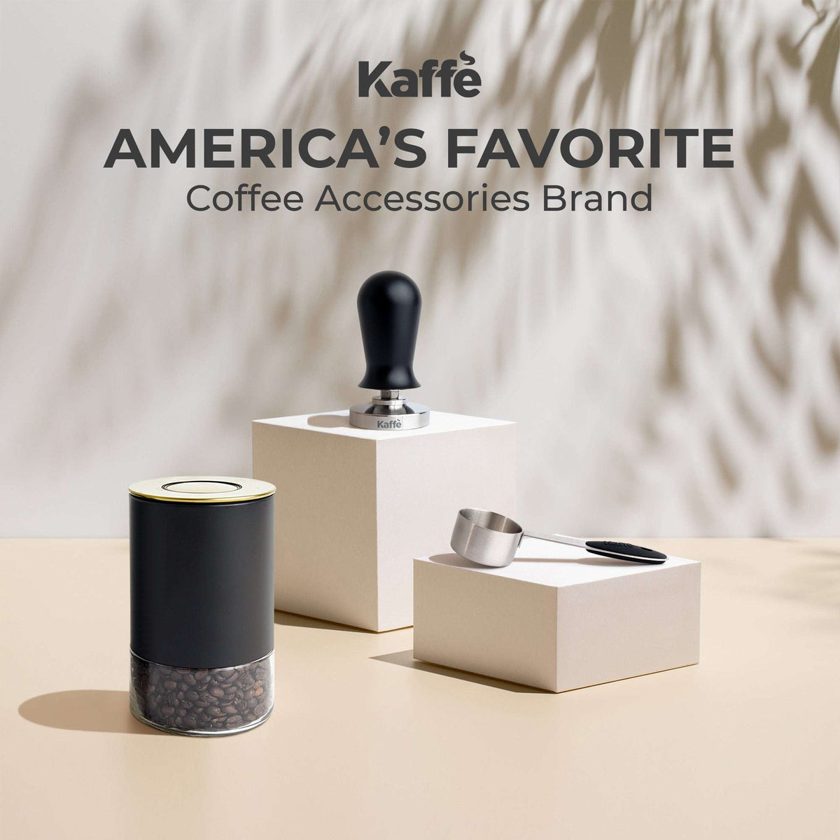 Matte black round glass storage container with stainless lid, on countertop