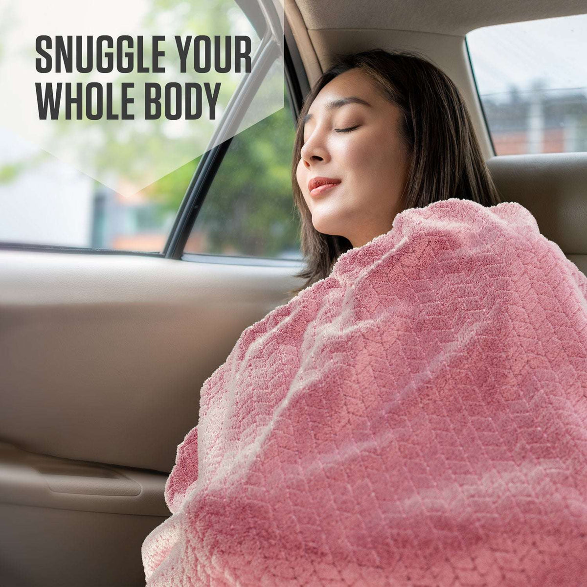 Micro plush travel blanket, pink, draped over shoulders in car