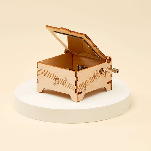 Assembled wooden DIY music box with open lid and side crank handle