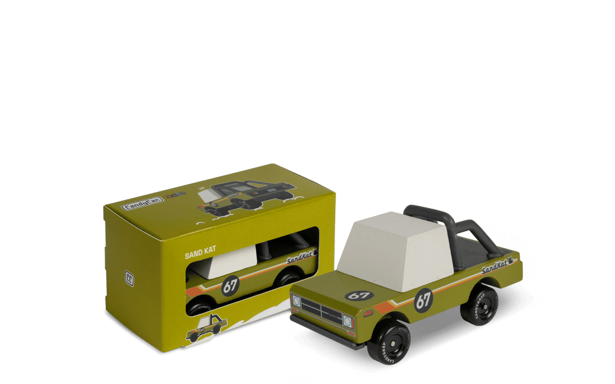 Toy pickup truck in green and black with white cab, shown with yellow product box