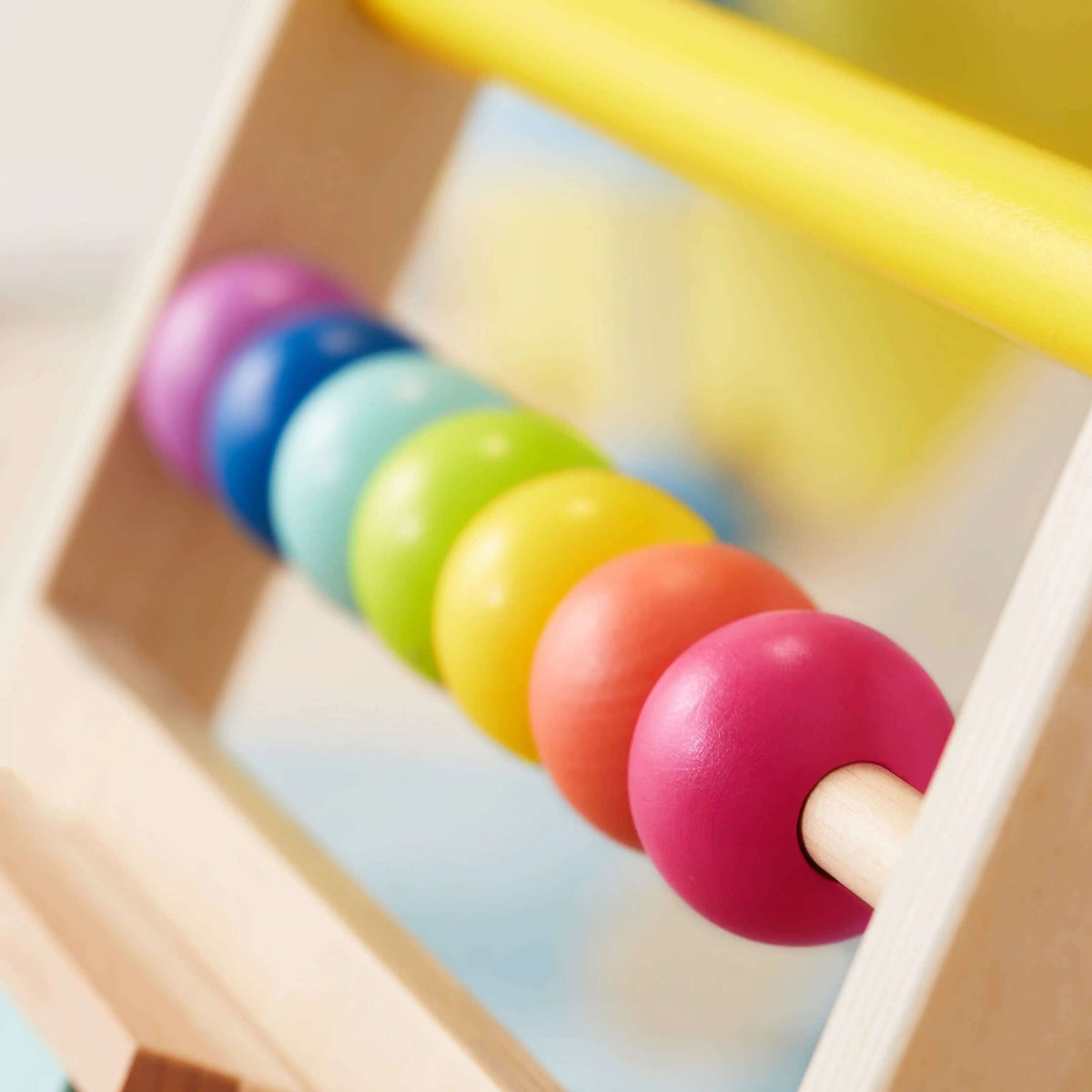 Bead track on wooden activity walker with multicolor balls and curved wooden base