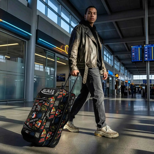 Black rolling duffel with multicolor print and extended telescoping handle