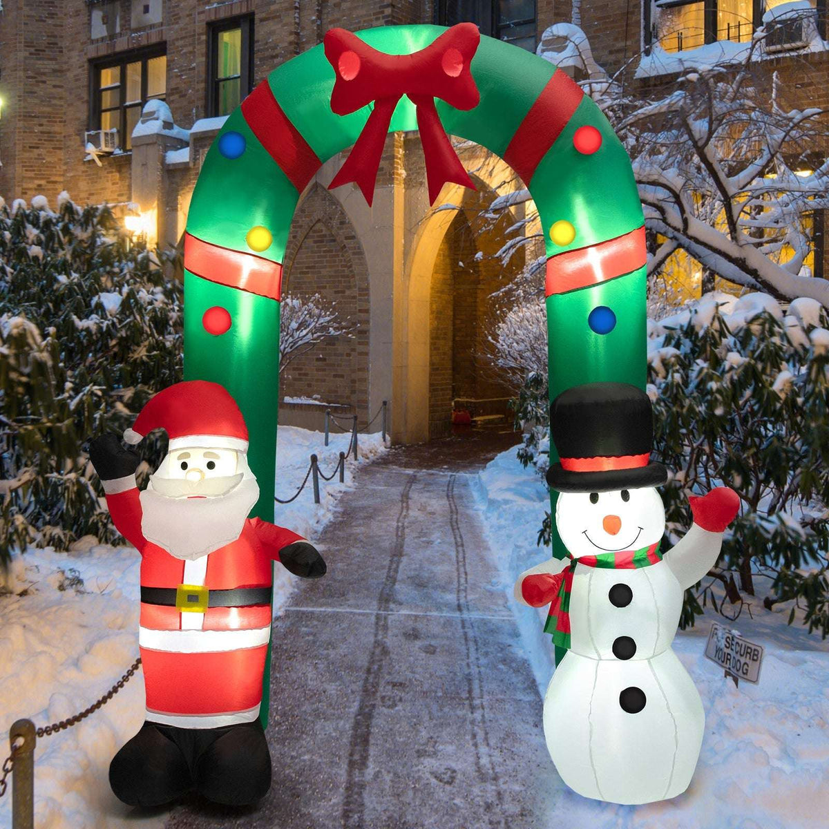 Inflatable Christmas arch with Santa and snowman displayed in a snowy entryway