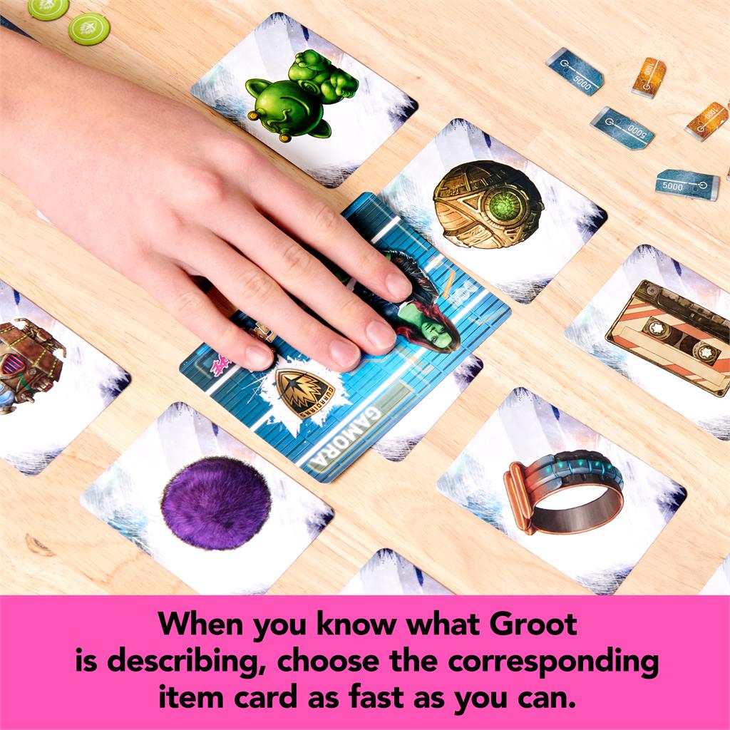 Hands placing item cards on a table for Groot Escape card game