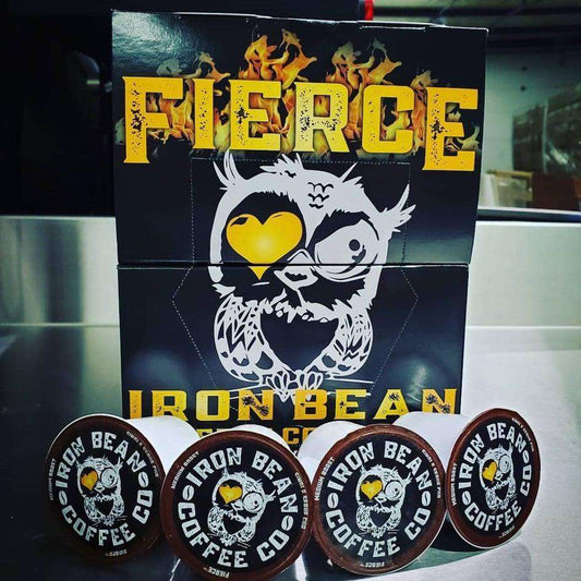 Coffee pod box and four dark roast pods with Fierce Iron Bean Coffee Company branding