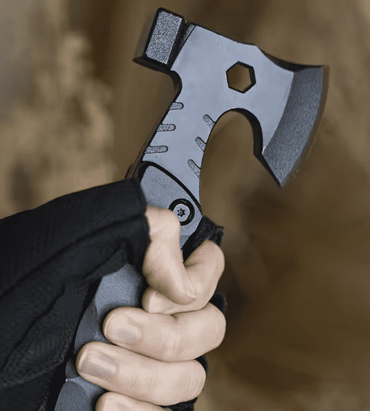 Multi-function hatchet hammer head with saw teeth, gripped by hands outdoors