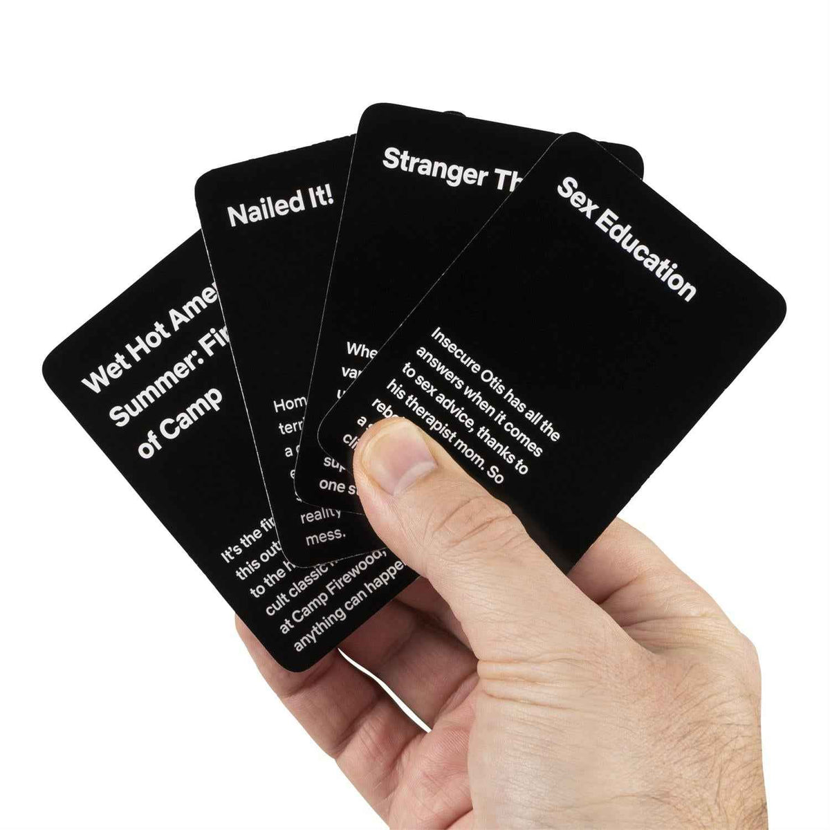 Hand holding Netflix Trending Now scenario cards from a black deck with red icon