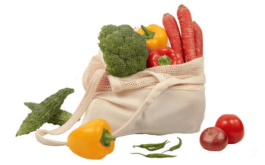 Organic cotton mesh tote bag filled with vegetables like broccoli, peppers, and tomatoes.