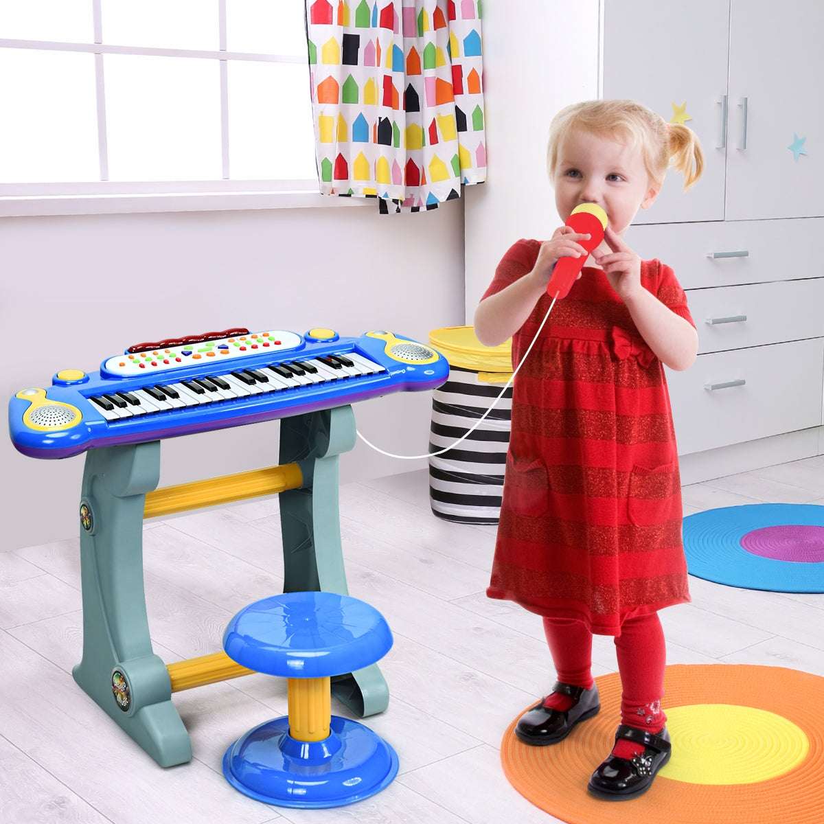 Blue kids' keyboard with microphone, stand, and stool shown in use