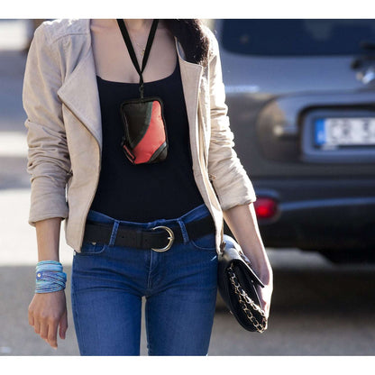 Black and orange zippered armband phone case worn on chest with lanyard