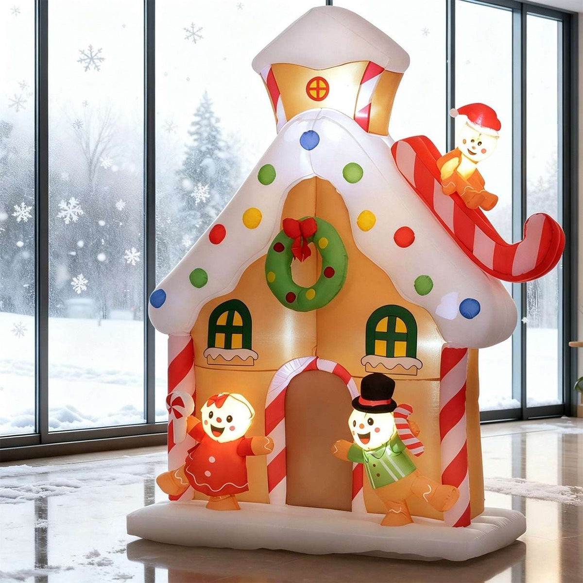 Inflatable gingerbread house with glowing figures, colorful candy decorations and a snowman on a sleigh