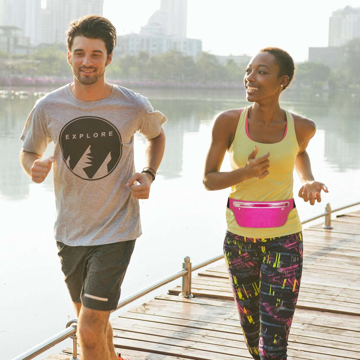 Pink running waist pack worn at the waist, slim profile with zipper pocket and black belt
