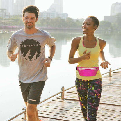Pink running waist pack worn at the waist, slim profile with zipper pocket and black belt
