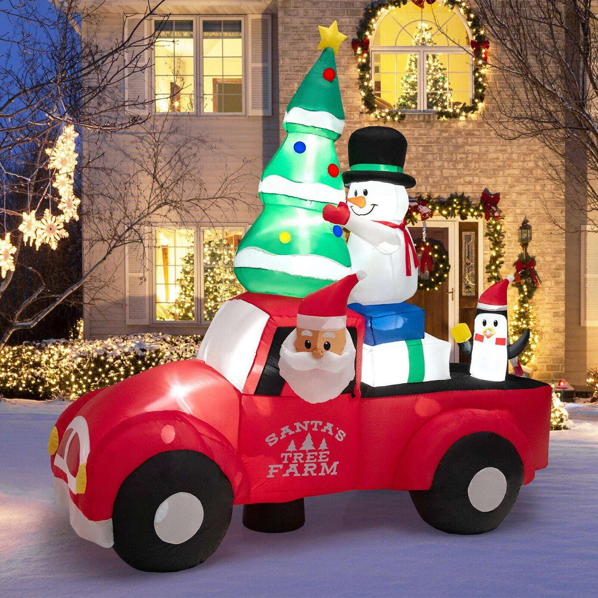 Inflatable Christmas pickup with Santa, a decorated tree, snowman and penguin; LED-lit display.