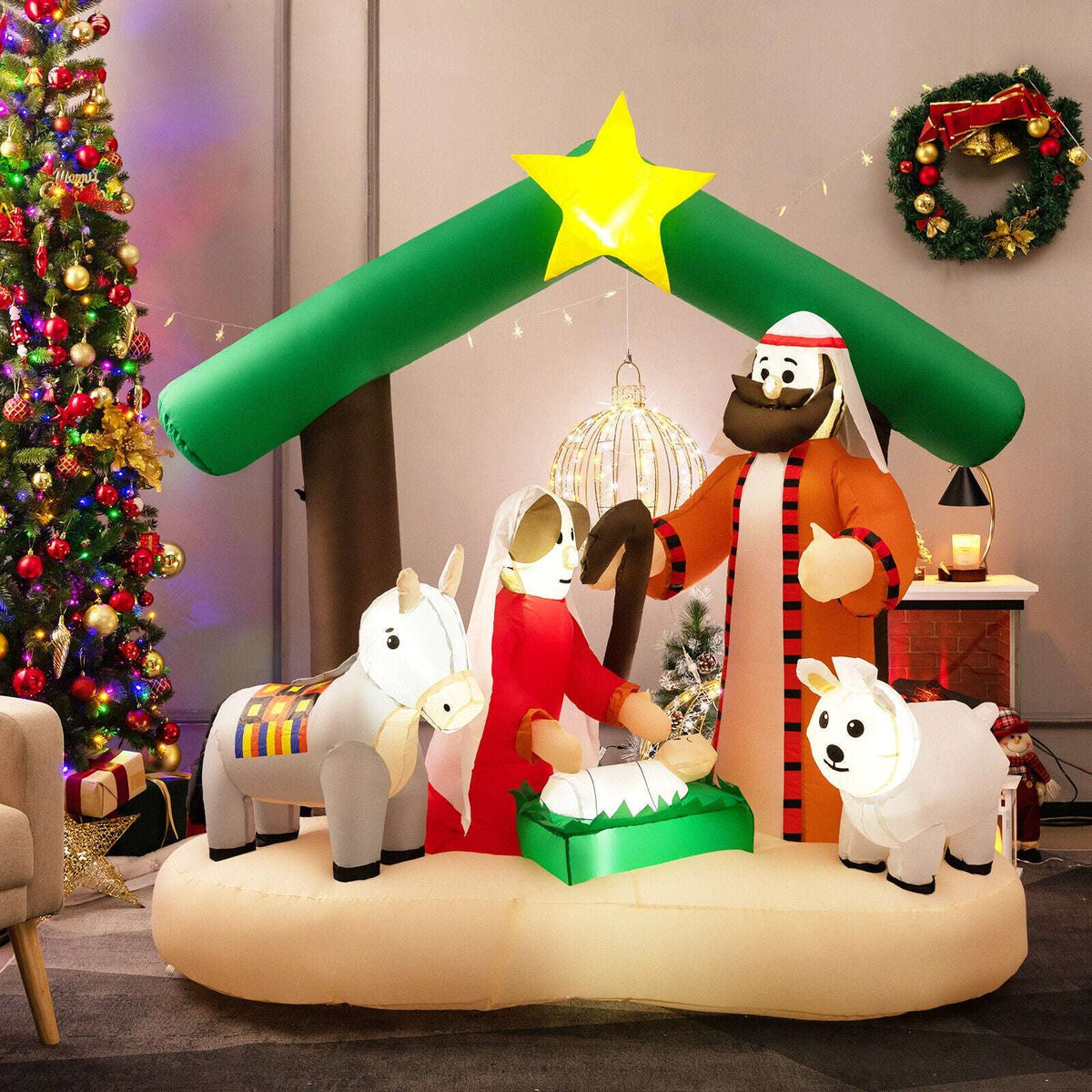 Inflatable nativity scene with a green stable roof, glowing star, Mary, Joseph, baby Jesus and animals