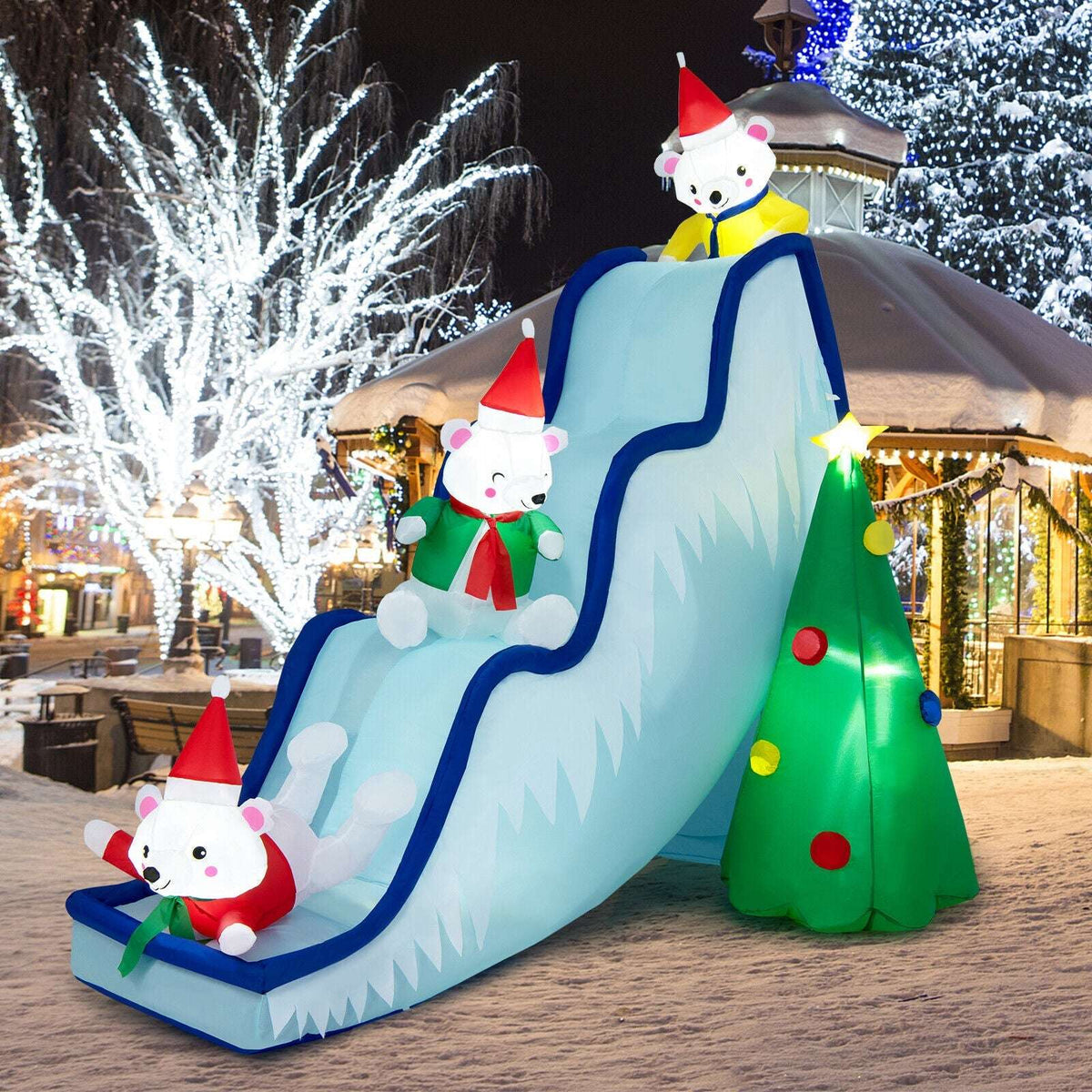 Inflatable polar bear slide with three bears, blue side rails, a lit tree and LED lights