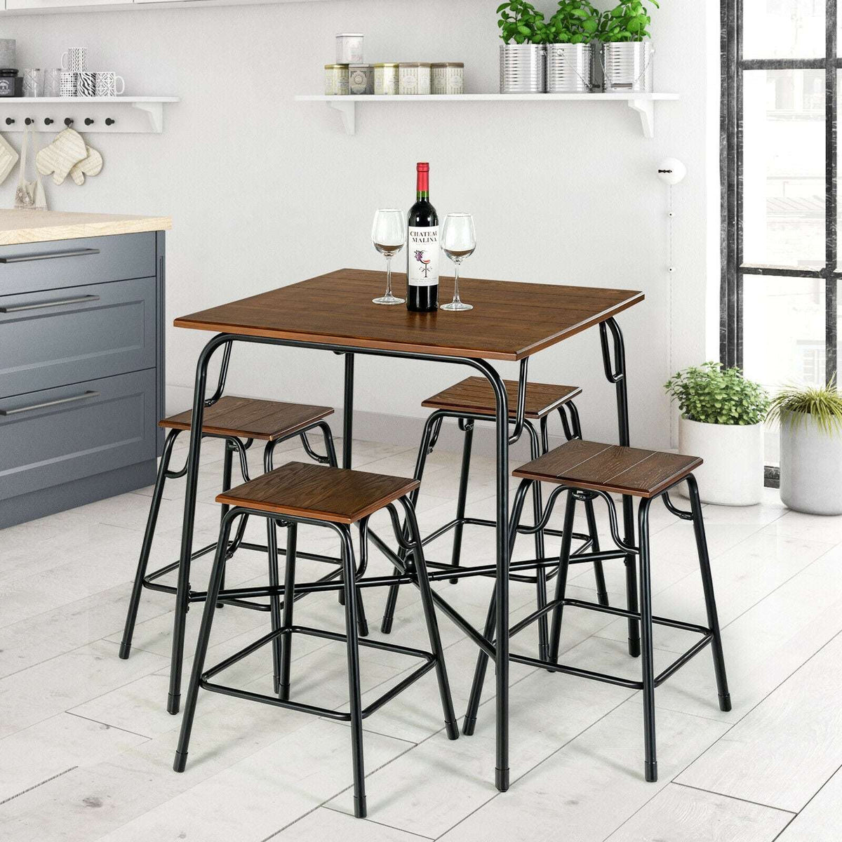 Five-piece bar table set with four backless stools in a kitchen, featuring rustic brown tops.