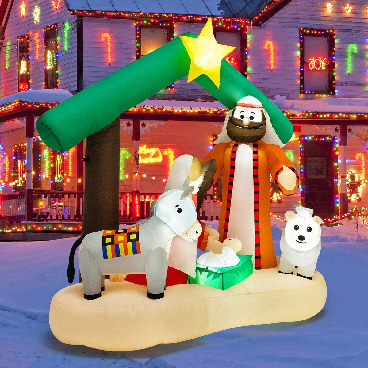 Inflatable nativity scene with green stable roof, glowing star, Mary, Joseph, baby Jesus, donkey and sheep