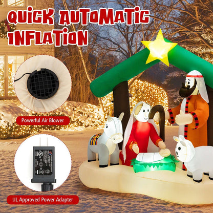 Inflatable nativity scene with star-topped stable, Holy Family and animals; air blower and adapter shown
