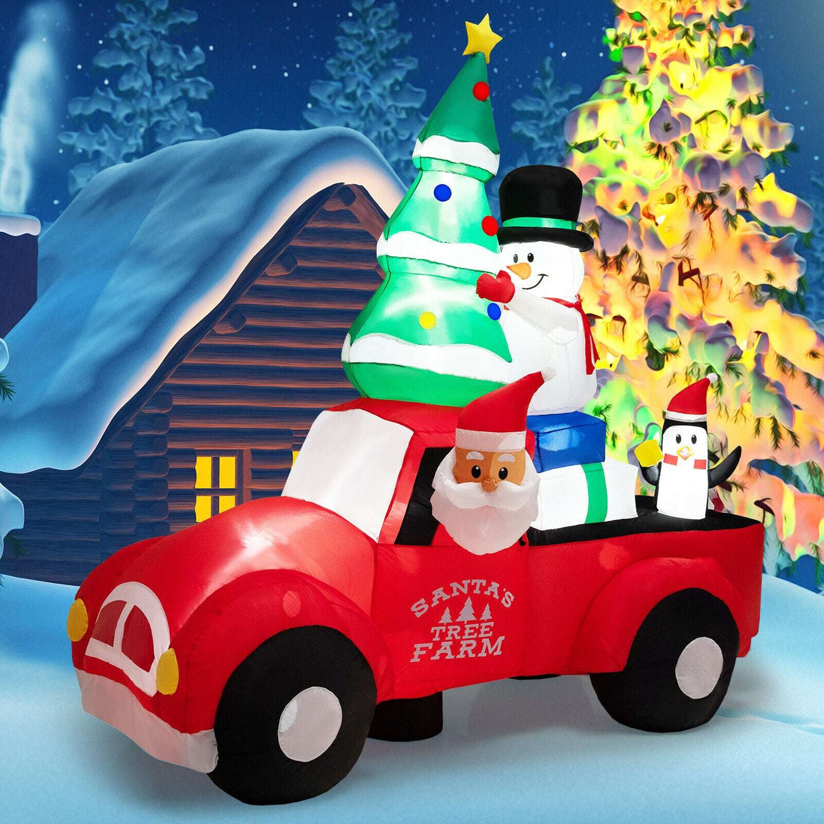 Inflatable Christmas pickup with Santa, decorated tree, snowman and penguin figures.