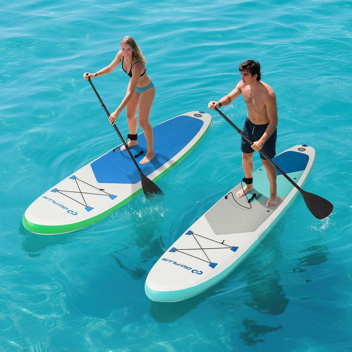 White, blue, and green inflatable paddle boards with paddlers using black paddles