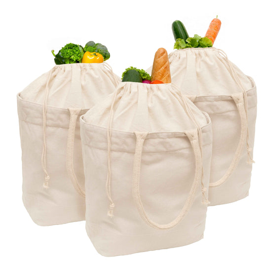 Cream canvas tote bag with drawstring, filled with vegetables