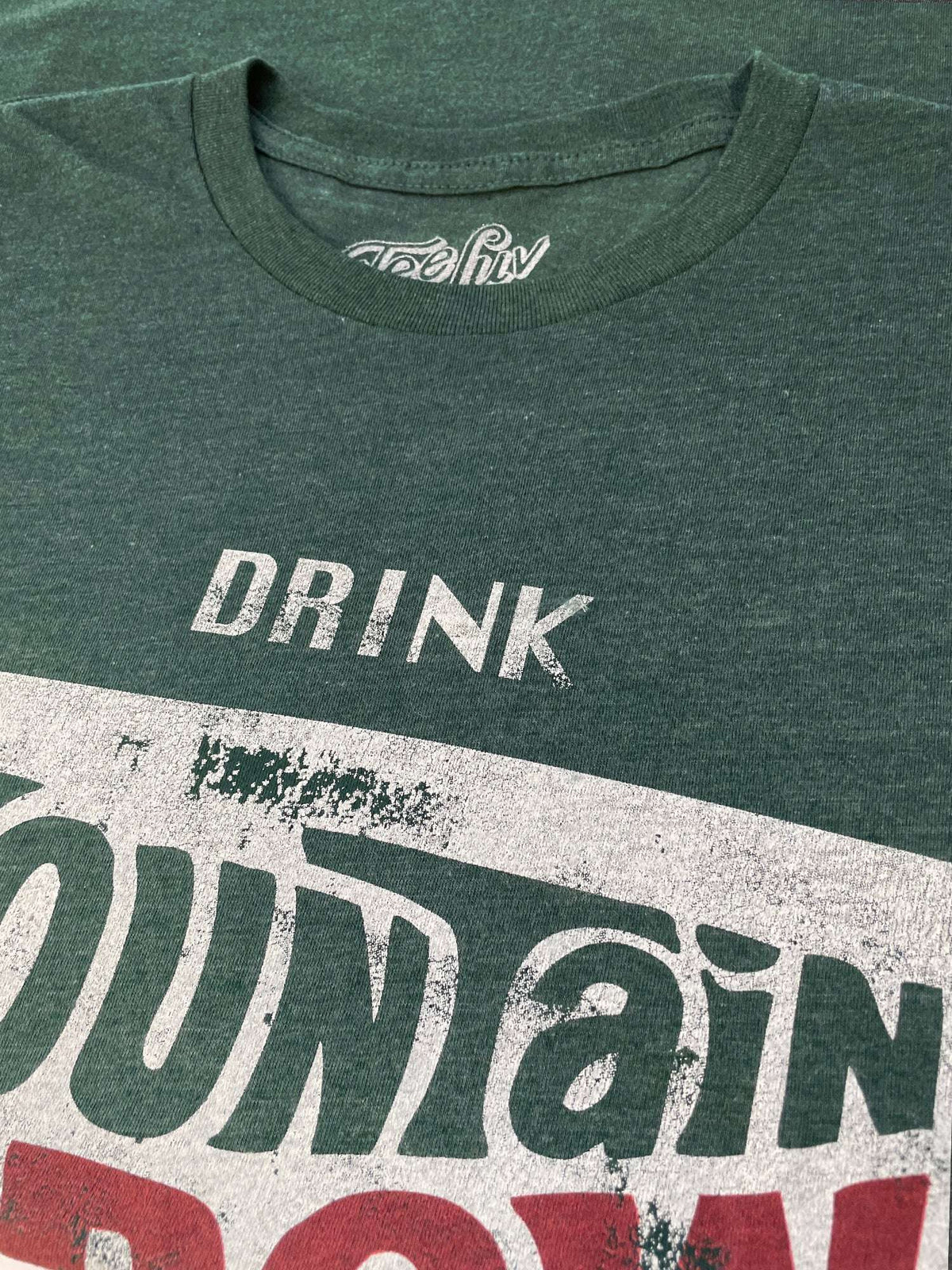 Forest green heather T-shirt collar and 'DRINK' Mountain Dew logo print close-up