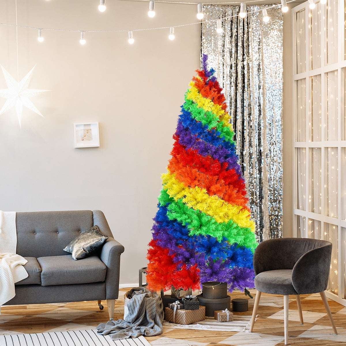 Multicolor artificial Christmas tree with broad rainbow bands and a metal stand