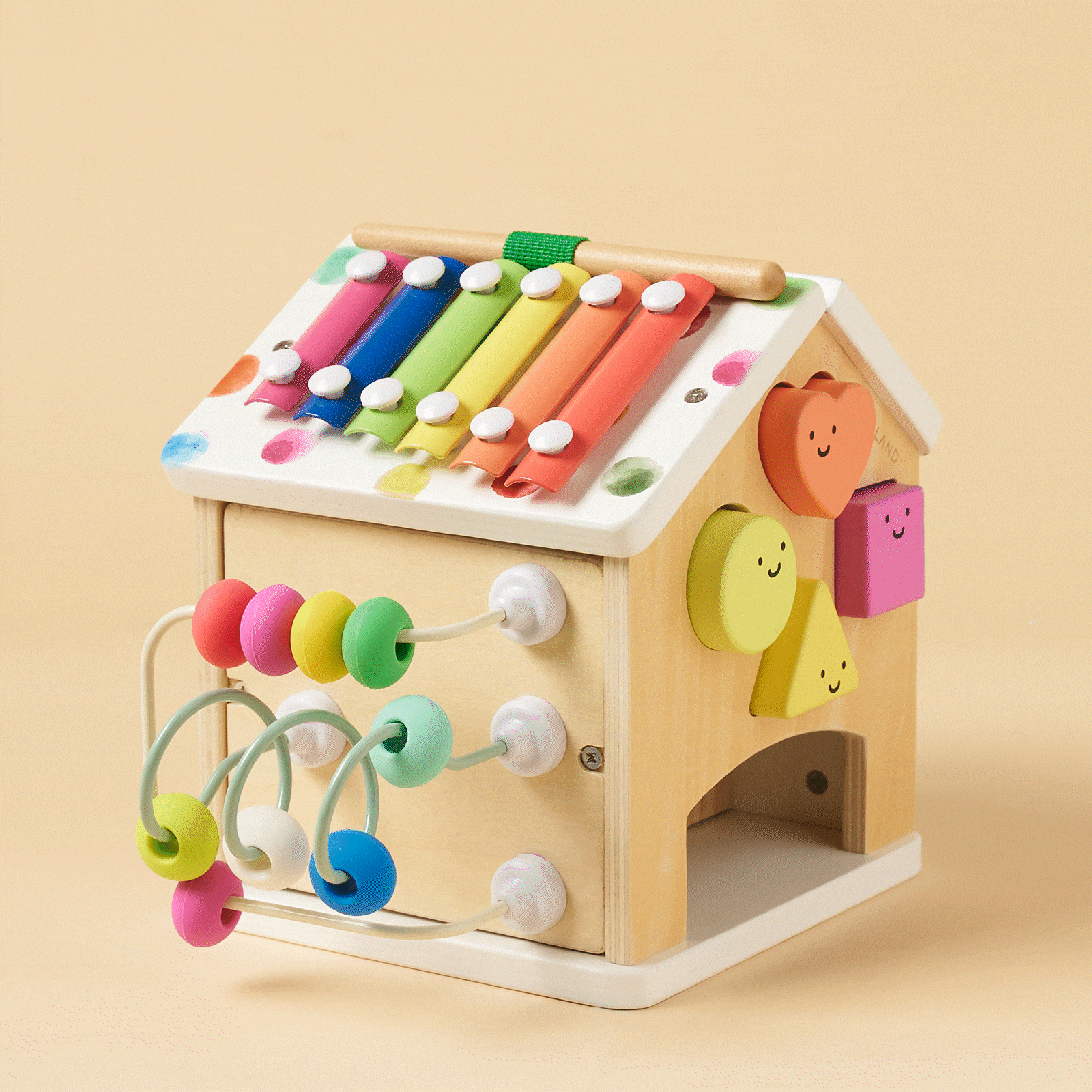 Wooden activity cube with rainbow xylophone bars and looped bead strings across sides