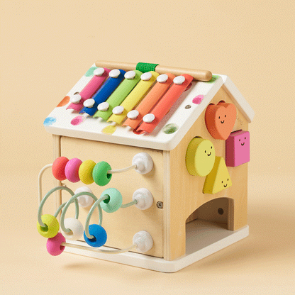 Wooden activity cube with rainbow xylophone bars and looped bead strings across sides