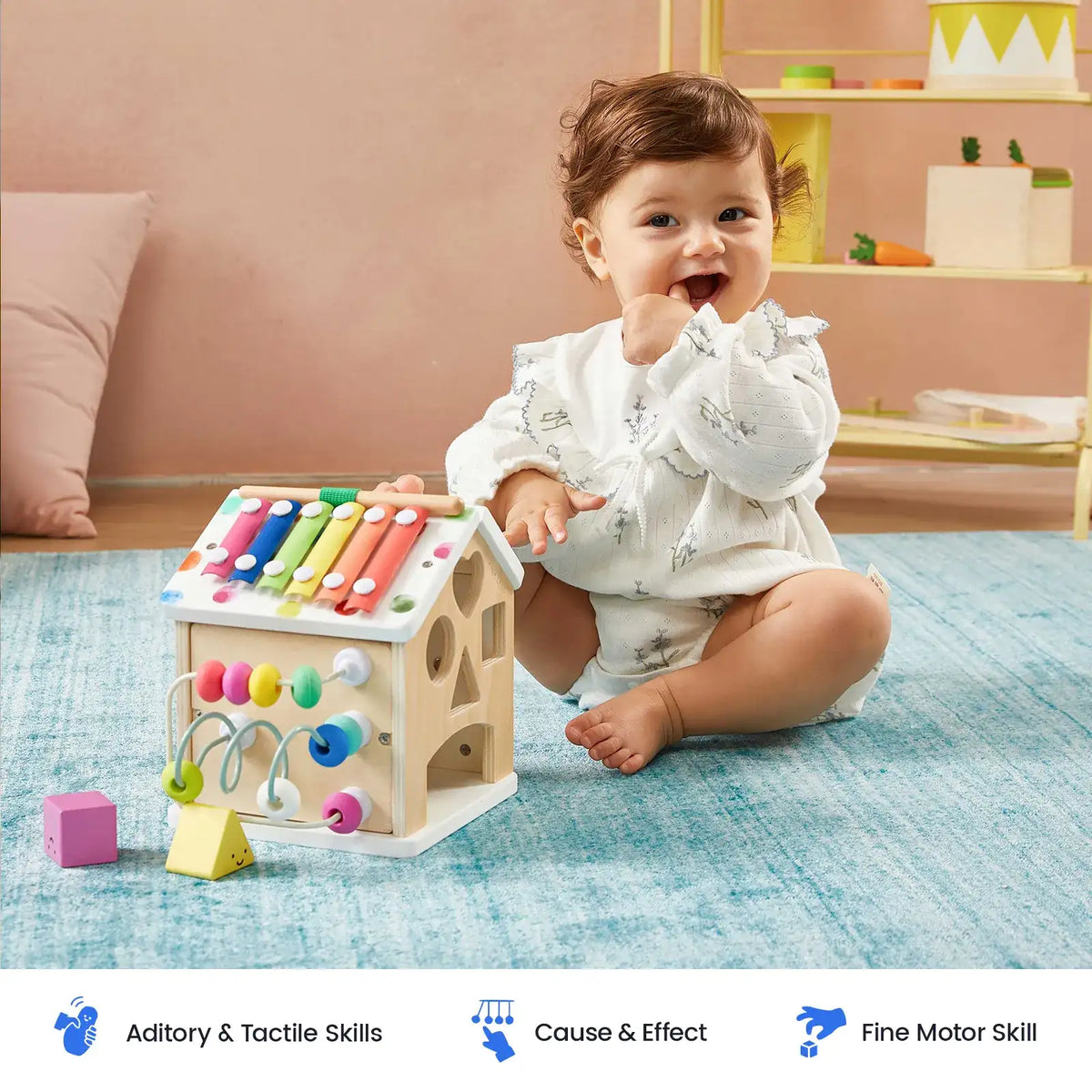 Wooden cottage activity cube with colorful xylophone top and bead maze on base
