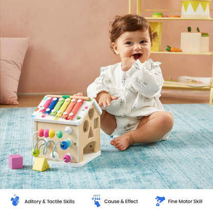 Wooden cottage activity cube with colorful xylophone top and bead maze on base