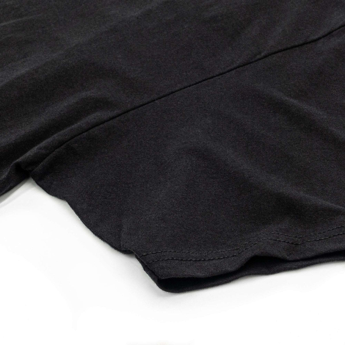 Black T-shirt with visible sleeve seam and curved hem