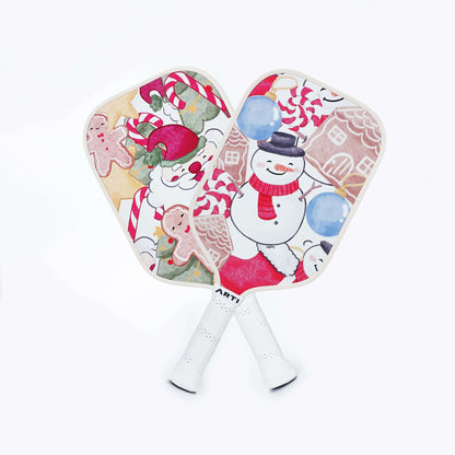 Pair of Christmas themed pickleball paddles with candy-cane and snowman artwork